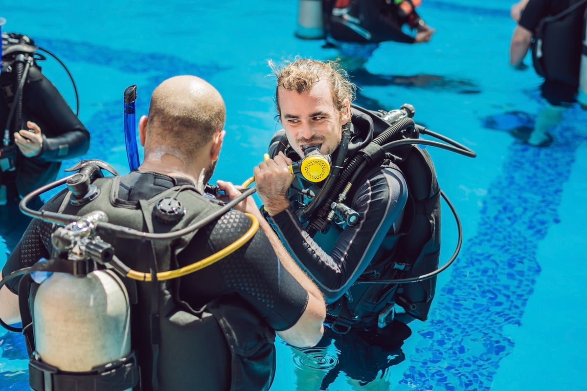 Diving Instructor and Students. Instructor Teaches Students to Dive